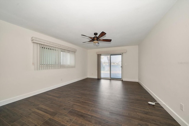 spare room with dark wood-type flooring and ceiling fan