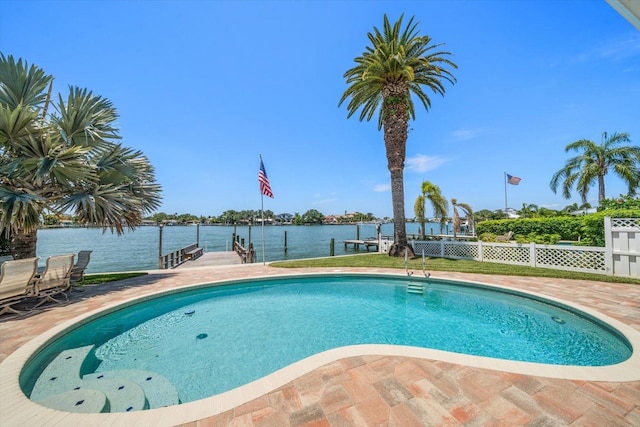 view of swimming pool with a water view and a dock