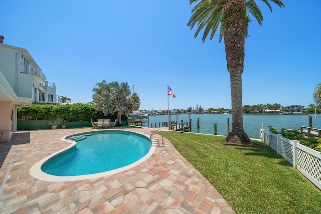 view of pool with a water view, a yard, a dock, and a patio