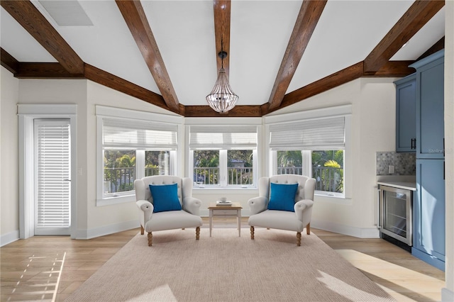 living area featuring lofted ceiling with beams, a chandelier, beverage cooler, and light hardwood / wood-style floors