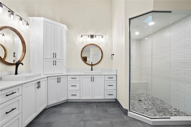 bathroom with vanity, tile patterned floors, and tiled shower