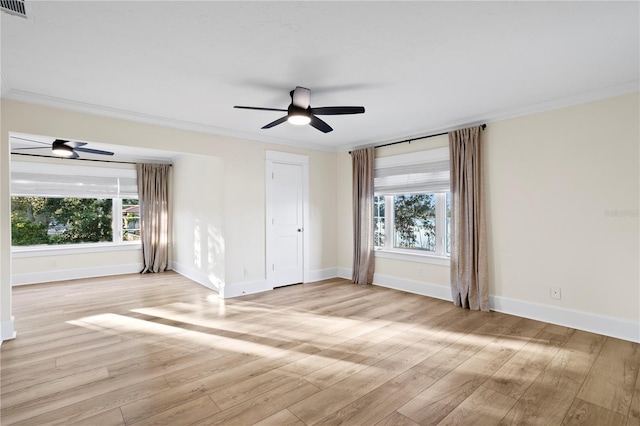 empty room with crown molding, plenty of natural light, ceiling fan, and light hardwood / wood-style flooring