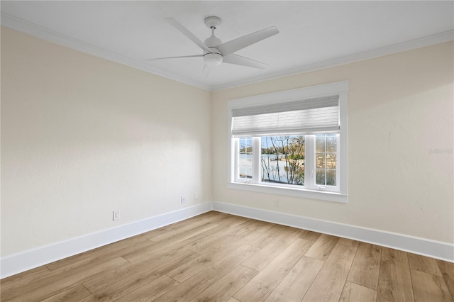 spare room featuring ceiling fan, ornamental molding, and light wood-type flooring