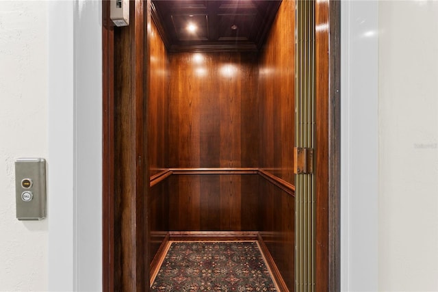 details with crown molding, coffered ceiling, and elevator