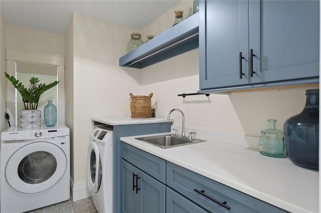 washroom with cabinets, separate washer and dryer, and sink