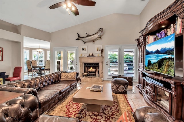 living room with a tile fireplace, high vaulted ceiling, and ceiling fan