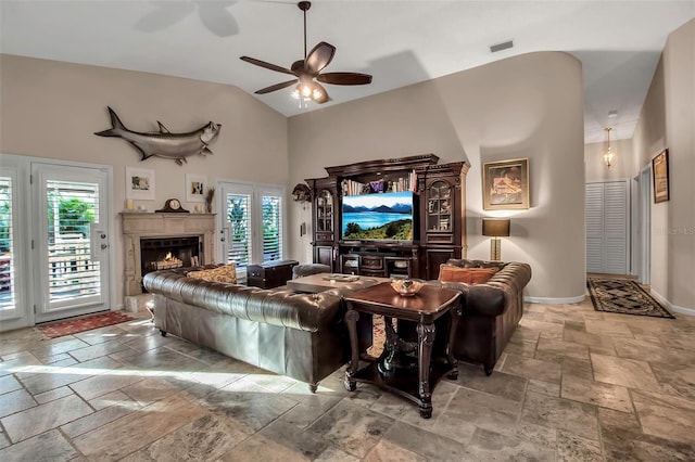 living room with ceiling fan and high vaulted ceiling