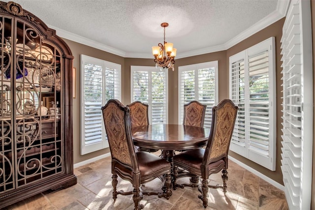 dining area featuring ornamental molding, a chandelier, and a textured ceiling