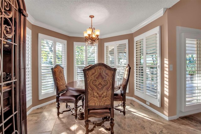 dining room featuring ornamental molding, a textured ceiling, and a chandelier