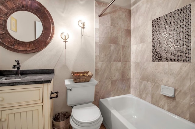 full bathroom featuring tiled shower / bath combo, vanity, and toilet