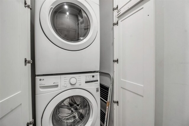 washroom with stacked washer and dryer