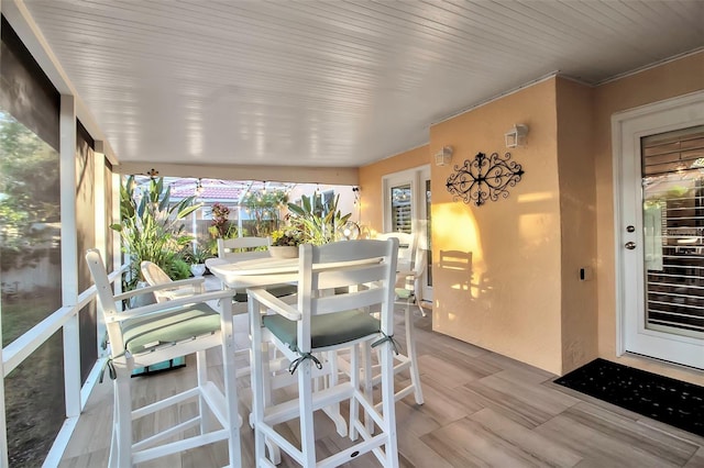 sunroom featuring wooden ceiling