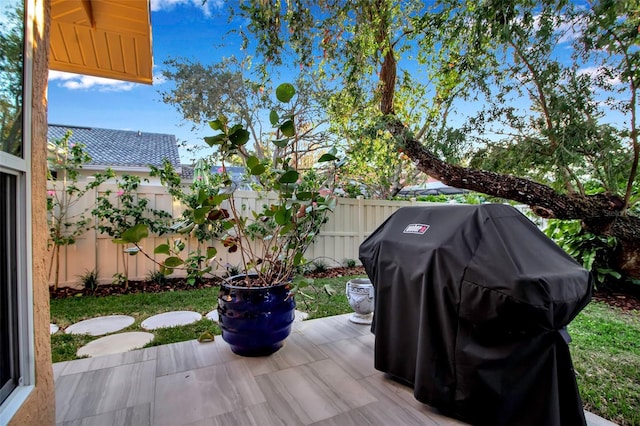 wooden terrace featuring area for grilling and a patio