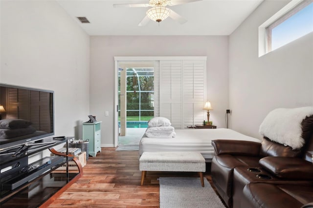 bedroom with ceiling fan, access to outside, and wood-type flooring