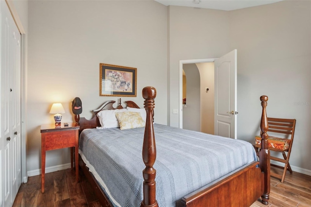 bedroom with hardwood / wood-style floors and a closet