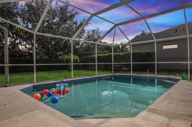 pool at dusk featuring a yard, a lanai, and a patio area