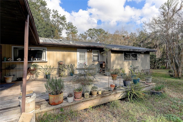 back of property with a wooden deck