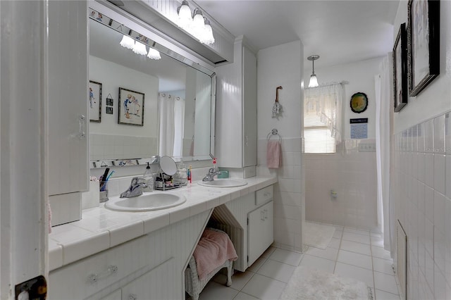 bathroom with tile patterned floors, tile walls, and vanity