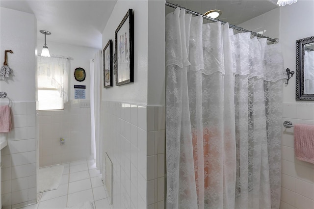 bathroom with tile patterned flooring, tile walls, and a shower with curtain