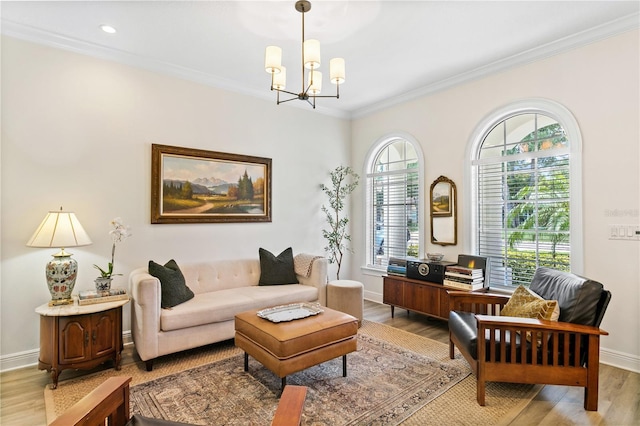 living area featuring ornamental molding, a notable chandelier, and light hardwood / wood-style floors