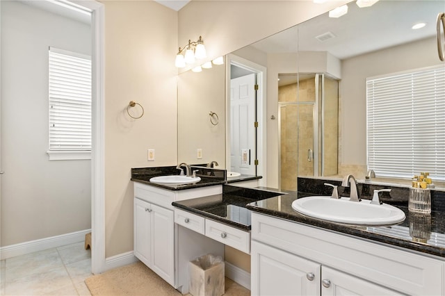 bathroom with vanity, tile patterned flooring, and a shower with door