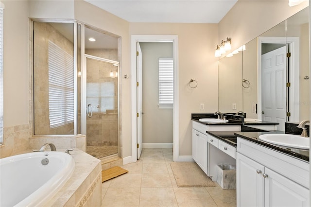 bathroom featuring vanity, shower with separate bathtub, and tile patterned flooring