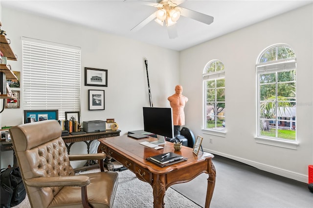 office area with plenty of natural light and ceiling fan