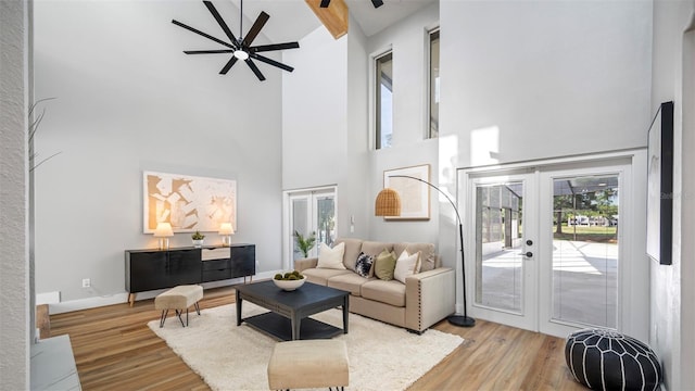 living room with french doors, a healthy amount of sunlight, and hardwood / wood-style floors