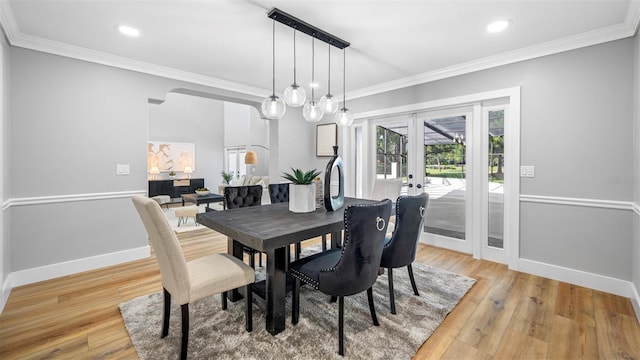 dining room featuring crown molding, hardwood / wood-style floors, and french doors