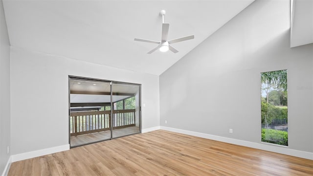 unfurnished room with hardwood / wood-style flooring, ceiling fan, and high vaulted ceiling