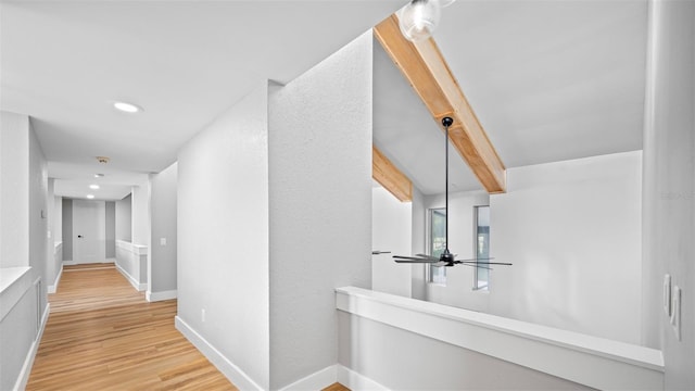 hall featuring beamed ceiling and wood-type flooring