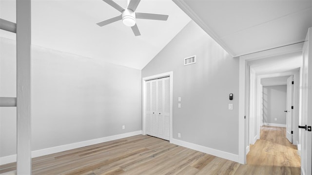 spare room featuring light hardwood / wood-style flooring, ceiling fan, and vaulted ceiling