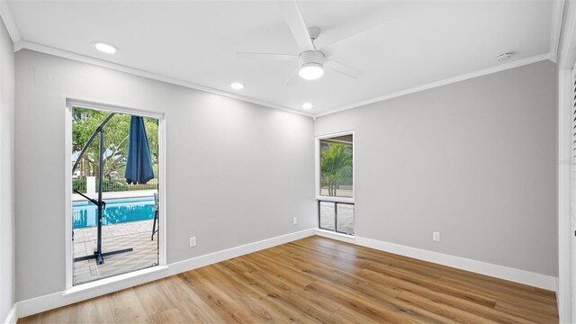 empty room with crown molding, hardwood / wood-style flooring, and ceiling fan