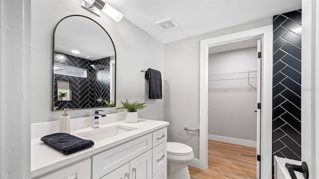 bathroom featuring hardwood / wood-style flooring, vanity, and toilet