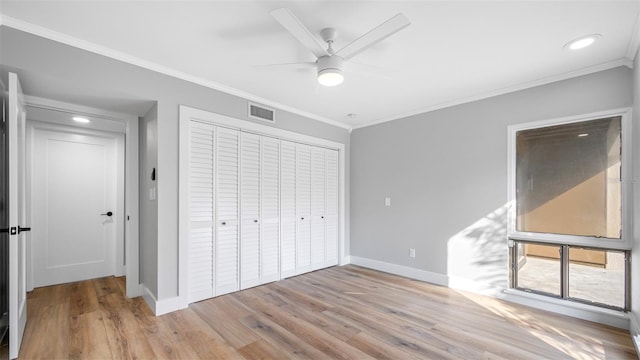 unfurnished bedroom with ornamental molding, a closet, and light hardwood / wood-style flooring