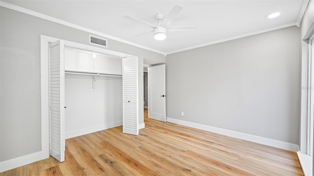 unfurnished bedroom featuring crown molding, ceiling fan, light hardwood / wood-style floors, and a closet