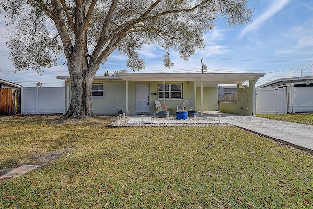 rear view of house featuring a yard and a carport