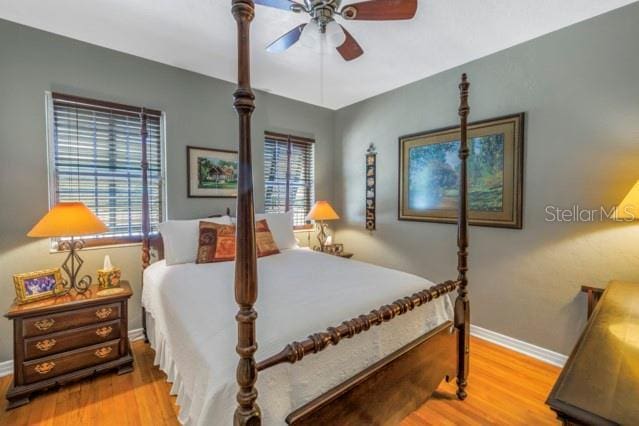 bedroom with ceiling fan and light wood-type flooring