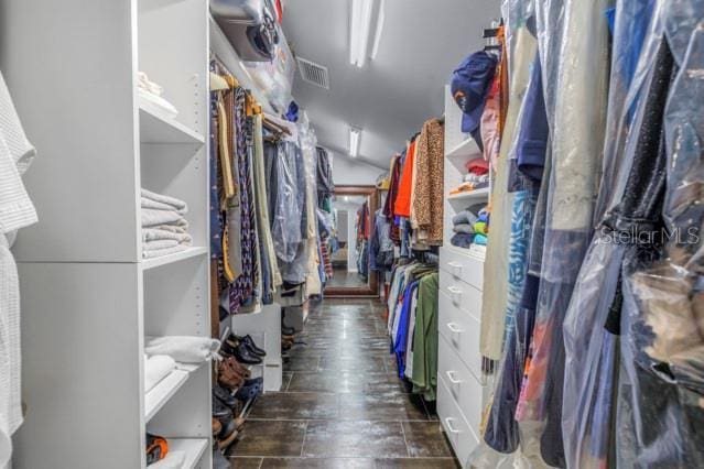 walk in closet featuring vaulted ceiling