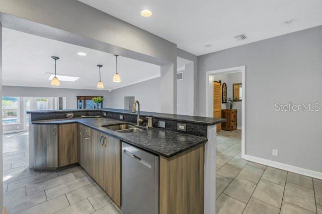 kitchen featuring sink, decorative light fixtures, light tile patterned floors, dishwasher, and dark stone counters