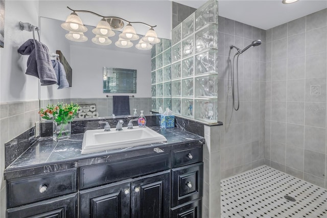 bathroom with vanity and a tile shower