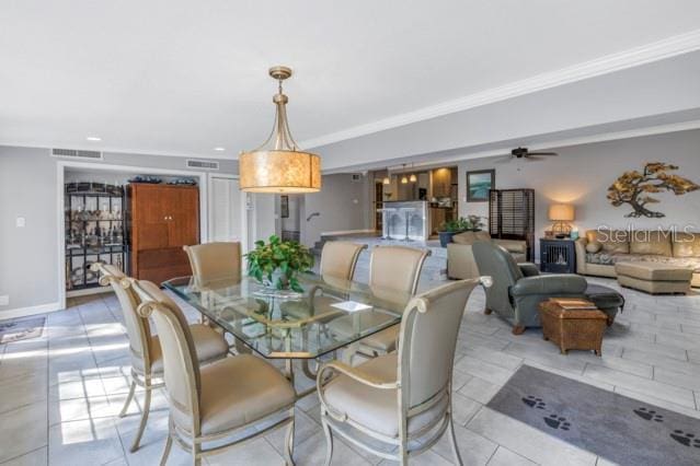 dining room with ceiling fan and ornamental molding