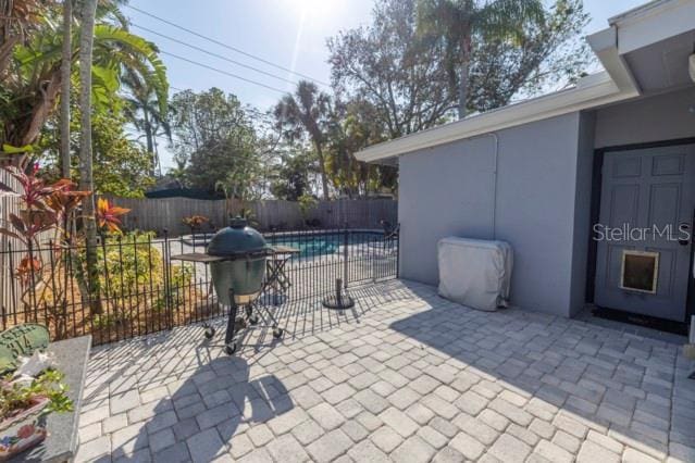 view of patio with a fenced in pool