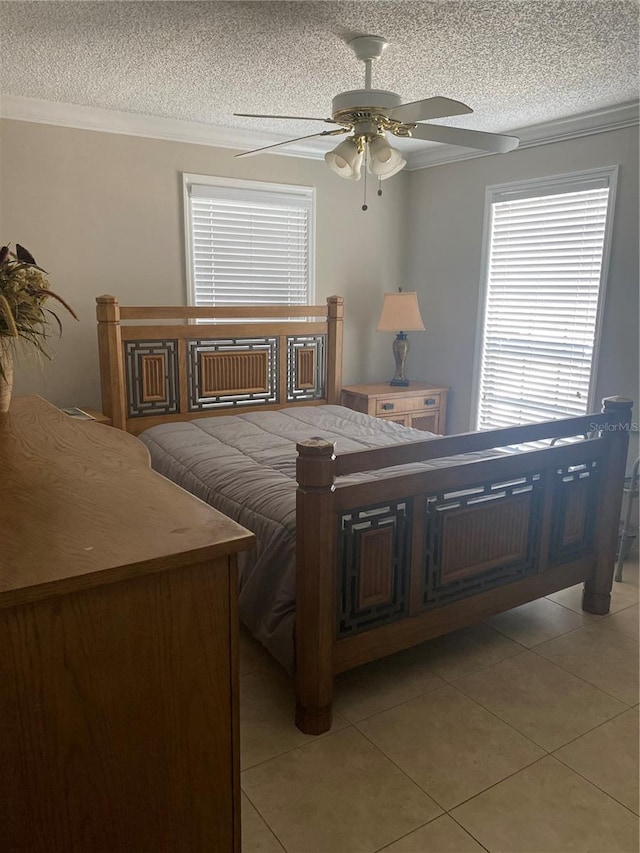 bedroom featuring crown molding, light tile patterned flooring, and a textured ceiling