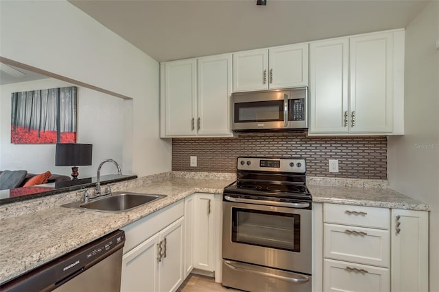 kitchen with sink, stainless steel appliances, and white cabinets