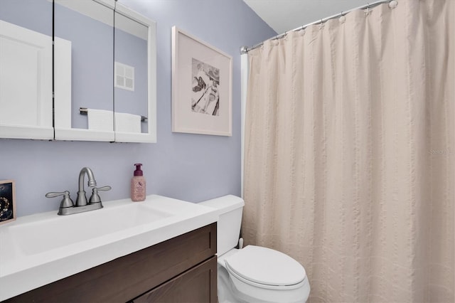 bathroom featuring a shower with curtain, vanity, and toilet