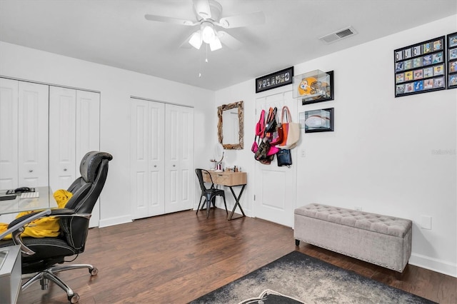 home office with ceiling fan and dark hardwood / wood-style flooring
