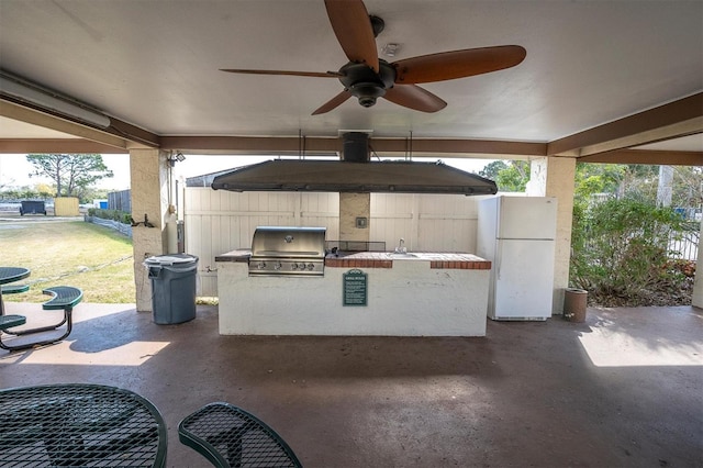 view of patio / terrace with sink, grilling area, ceiling fan, and exterior kitchen