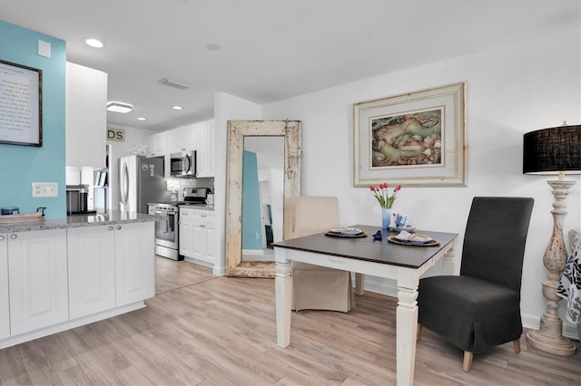 home office with light hardwood / wood-style floors