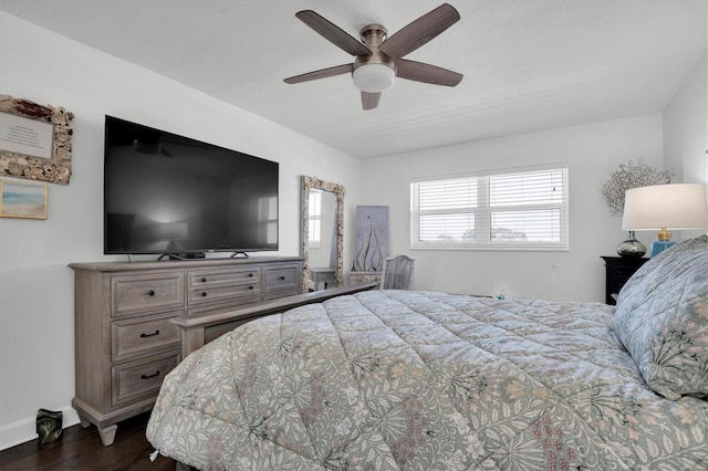 bedroom with dark wood-type flooring, ceiling fan, and multiple windows